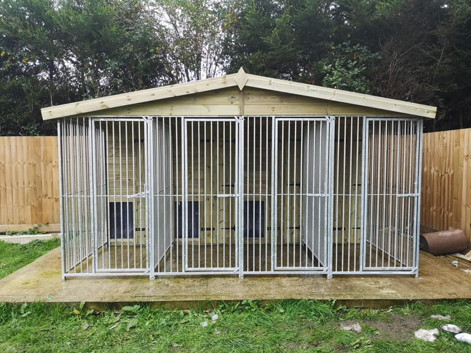 Dogs keeping warm in their wooden kennels